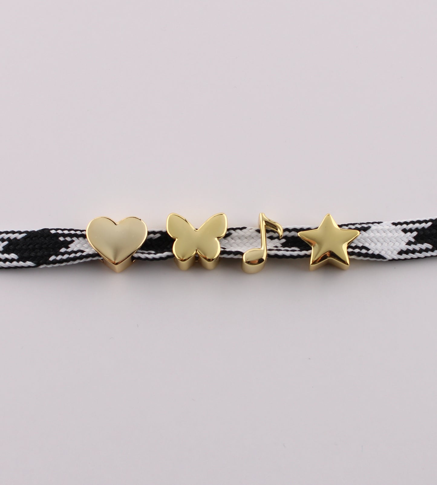 Gold emoji sneaker charms heart butterfly music note and star on black checkered shoelace