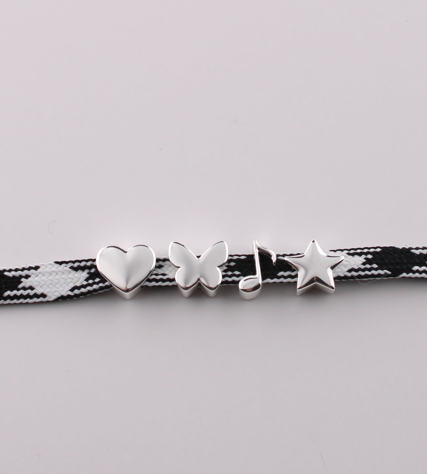 Silver emoji sneaker charms heart butterfly music note and star on black checkered shoelace - silver emoji charms