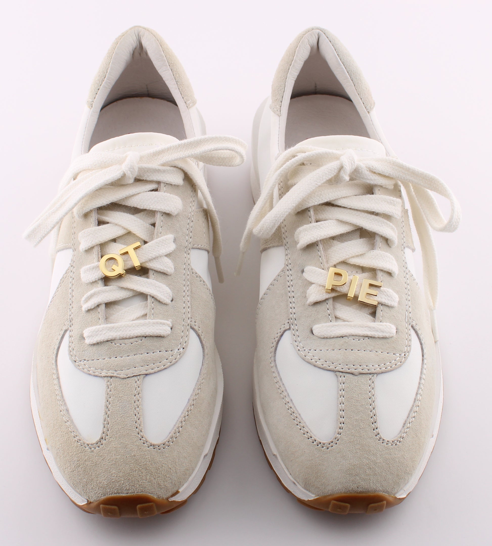Light gray sneakers with gold Cutie Pie letter charms OT PIE on white shoelaces