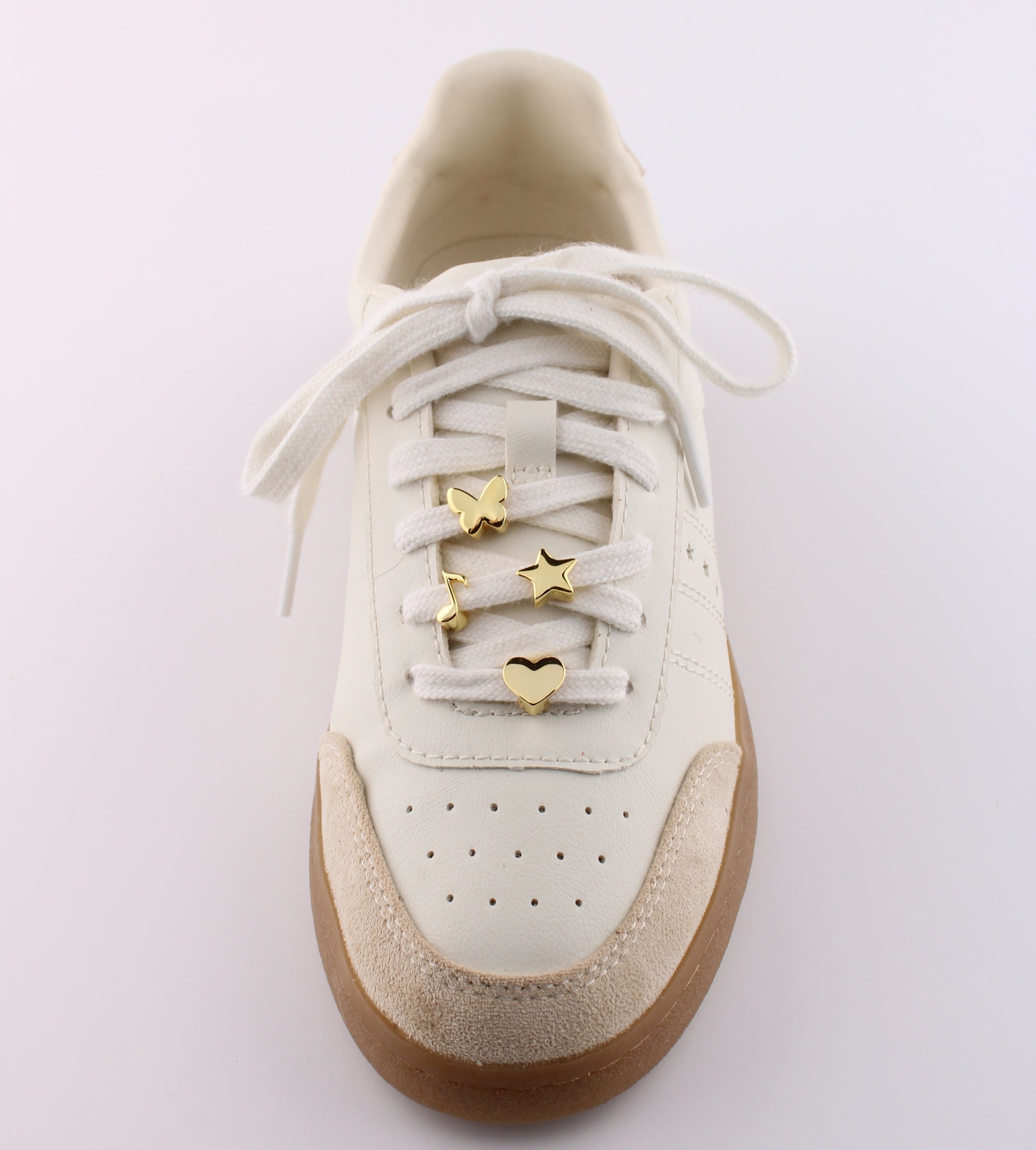 White sneaker with gold emoji charms butterfly star and heart on white shoelaces - gold emoji sneaker charms