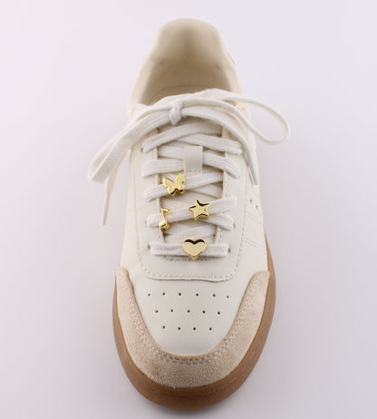White sneaker with gold emoji charms butterfly star and heart on white shoelaces - gold emoji sneaker charms