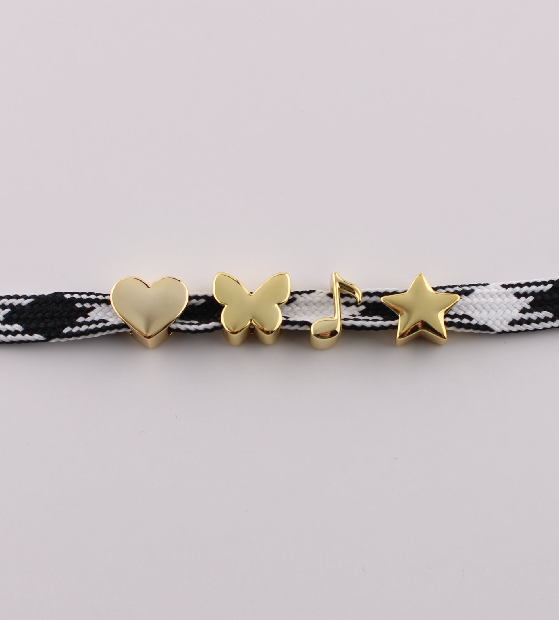 Gold emoji sneaker charms heart butterfly music note and star on black checkered shoelace
