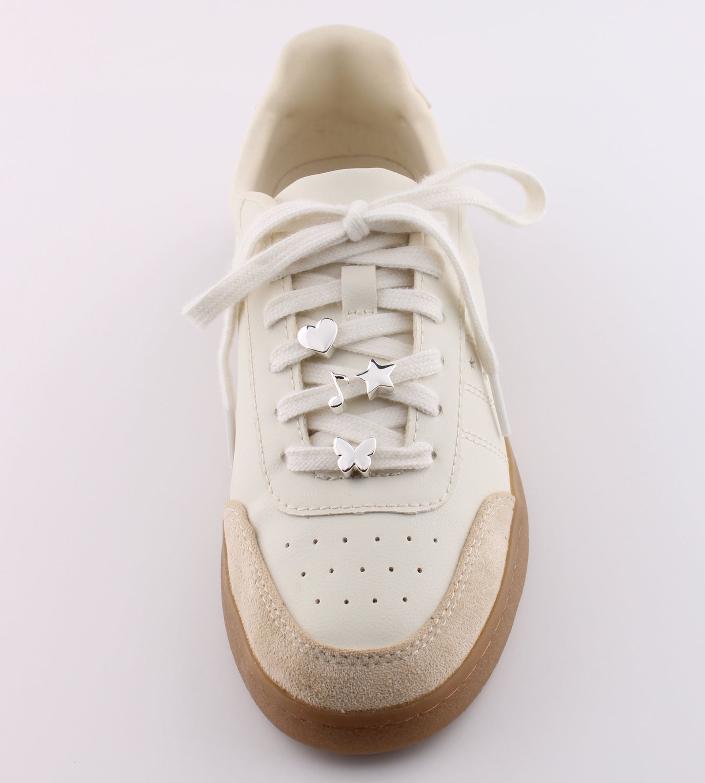 White sneaker with silver emoji charms heart star lightning and butterfly on white shoelaces - silver emoji sneaker charms